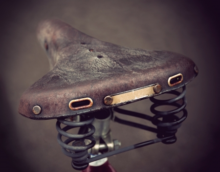 vintage leather bike saddle with metal spring の写真素材