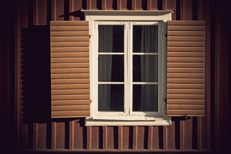 Vintage window with shutters on wooden wallの写真素材