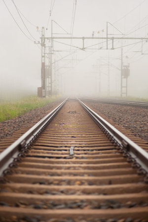 Low angle view of railroad tracks in heavy fog