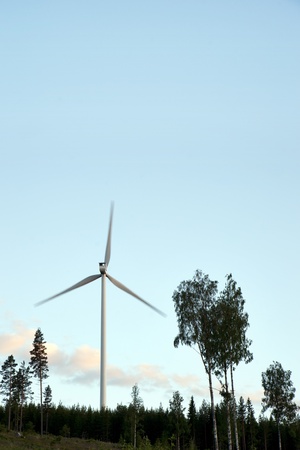 Rotating wind power generator in forest areaの写真素材