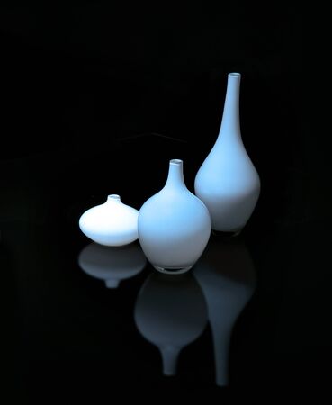 Still life with blue glass vases reflected in surfaceの写真素材
