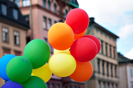 Bunch of balloons in front of urban buildingsの写真素材