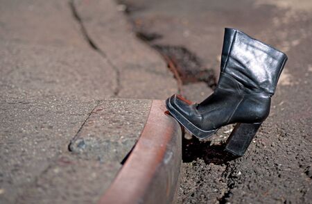 Leather boot with high heel on curbの写真素材
