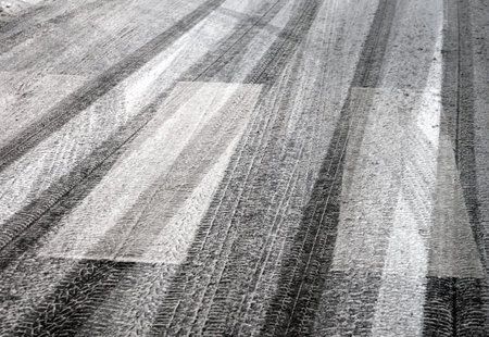 pedestrian crossing with snow and tyre prints