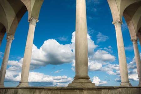 columns and arches of ancient roman building on blue skyの写真素材