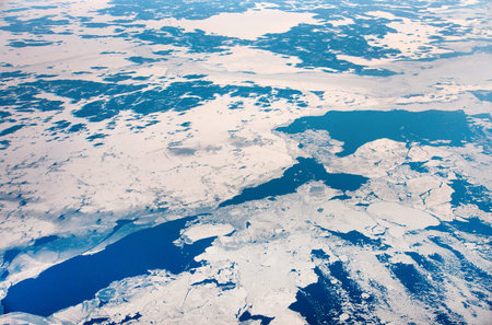 Winter landscape with ice floes in sea seen from above