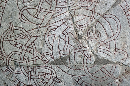 background with engraved runes on ancient stoneの写真素材