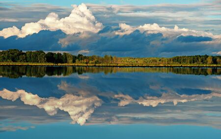 beautiful clouds reflected in lake on sunny dayの写真素材