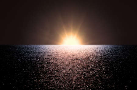 dawn with bright sun at sea with wavesの写真素材