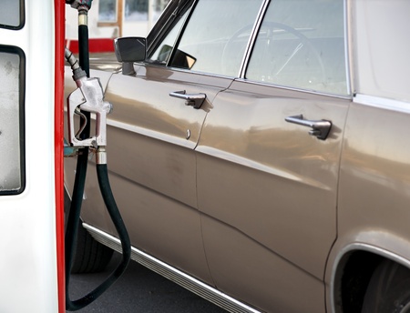 Vintage car at gas station, ready to be filled upの写真素材