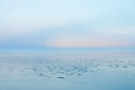 lake and blue and pink sky on misty morning