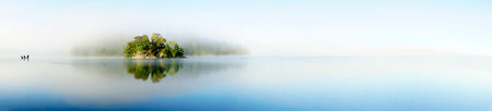 Panoramic view of island in lake on foggy morning