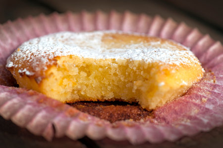 Close up of yummy lemon cupcake with powdered sugar