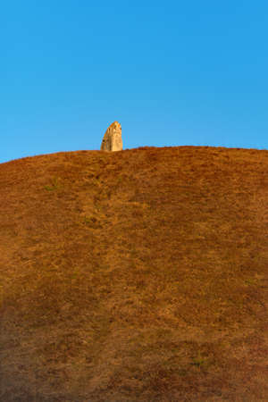 Standing stone on top of ancient viking graveの写真素材