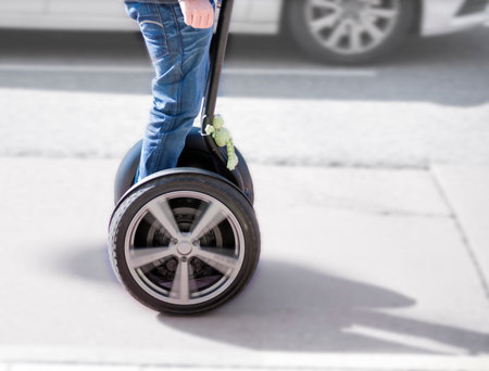Legs of man on segway in street