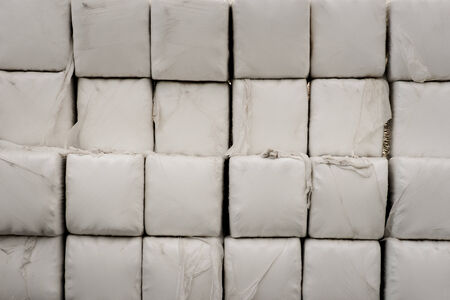 Close up of pile of hay bales wrapped in plasticの写真素材