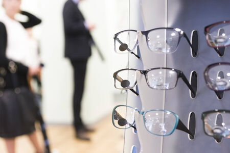 Glasses on display on wall in storeの写真素材