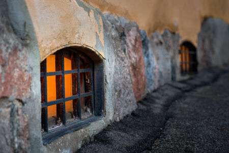 small window with metal grid on street levelのeditorial素材