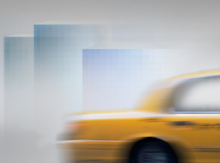 Yellow cab in blurred motion in abstract city landscapeの写真素材