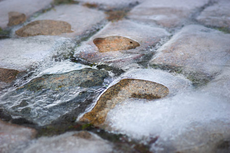 Background with cobble stones covered in ice
