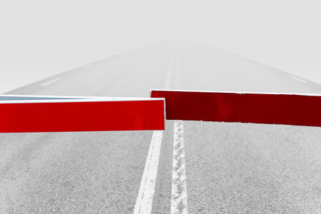 foggy road closed with red barriersの写真素材