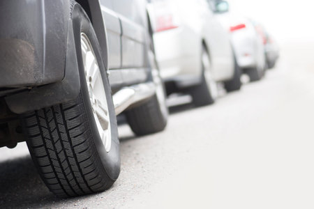 Low angle view of tire of car in traffic jam