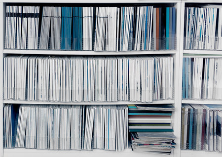White bookcase with many reports, magazines or other publicationsの写真素材