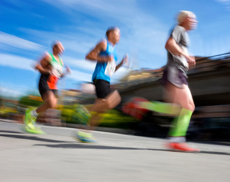 Three men in blurred motion in running competition