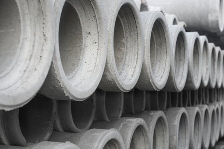 row of concrete pipes in pile with diminishing perspectiveの写真素材