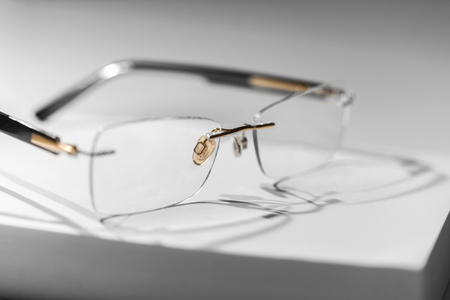 Sparse image with reading glasses on bookの写真素材