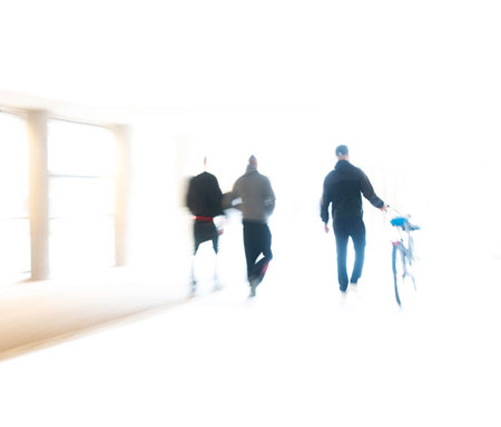 Rear view of three men and a bike in city