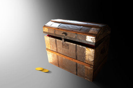 Slightly open treasure chest in bright light , with two gold coins on the floor