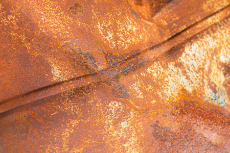 Dented smooth rusty red metal