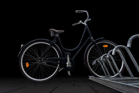 Low angle view of black traditional parked bike on dark backgroundの写真素材