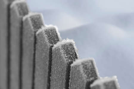 Wooden fence with ice crystals on cold winter dayの写真素材