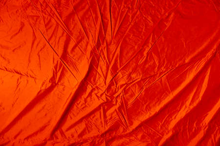 Background with creased wet orange canvasの写真素材