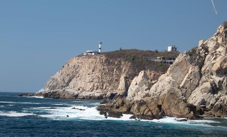 Blue ocean in huatulco bay and rock formationsの写真素材