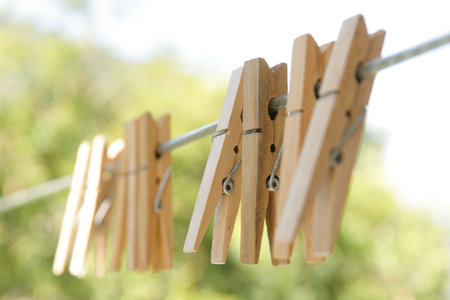 Close up of a wooden clothespins on a clothesline