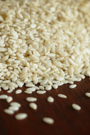 Close up of sesame seeds on a wood table