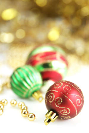 Three christmas balls with golden ornament in backgroundの写真素材