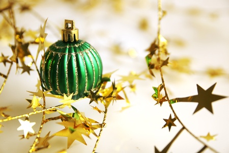 Green christmas ball with golden twinsel all aroundの写真素材