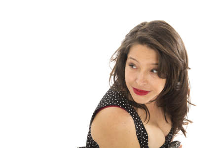 Brunette woman looking on the side on a white backgroundの写真素材