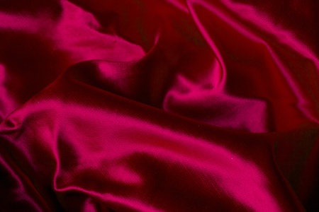 Shinny waves into a red satin fabricの写真素材