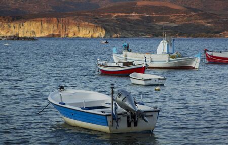 Little red and blue boats at dusk in Greeceの写真素材