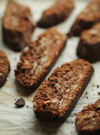 Fresh chocolate biscottis with almond on paperの写真素材