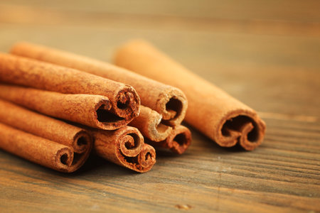 Bunch of cinnamon sticks on wooden table