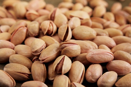 Close up of a shelled pistachio on a wooden tableの写真素材