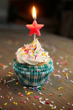 Birthday cupcake with a star candle on topの写真素材
