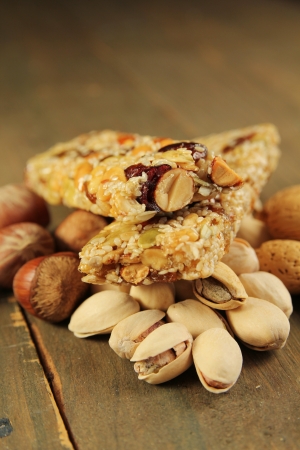 Two granola bar with nuts and dry fruits on a wooden tableの写真素材