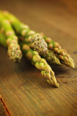 Fresh green asparagus on a wooden tableの写真素材
